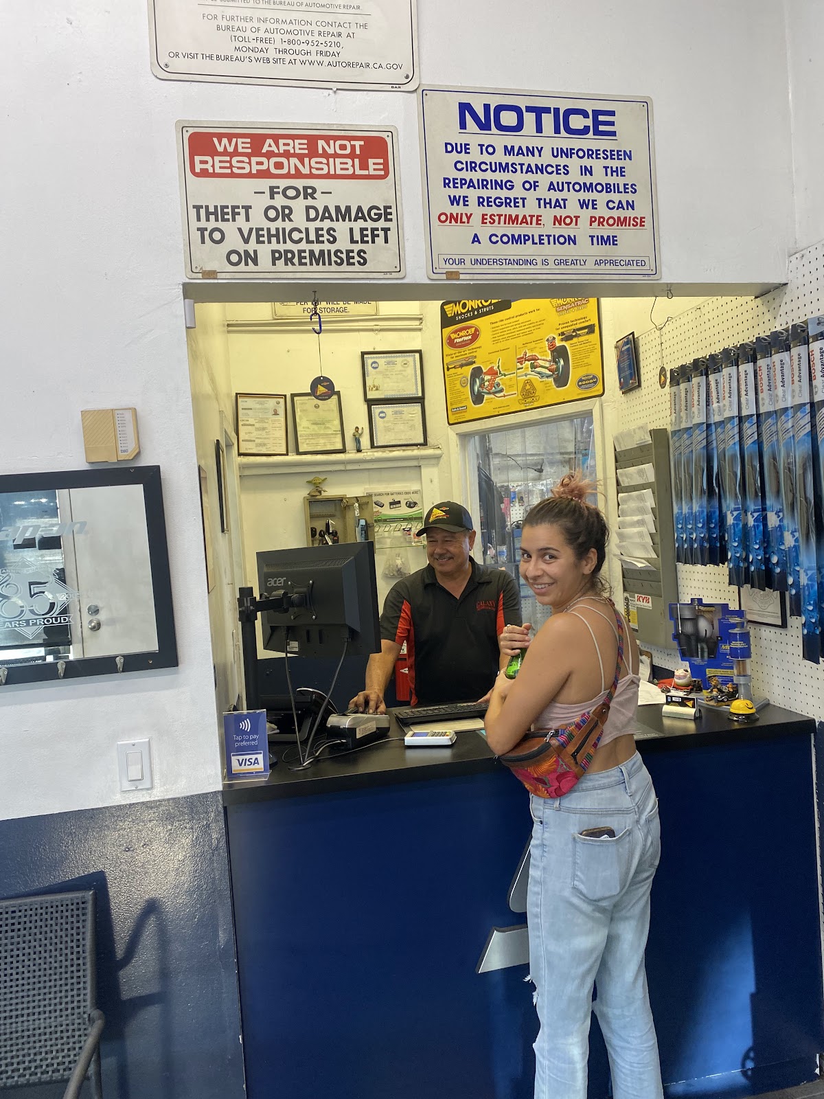 The front desk at Galaxy Automotive with a member of staff serving a customer
